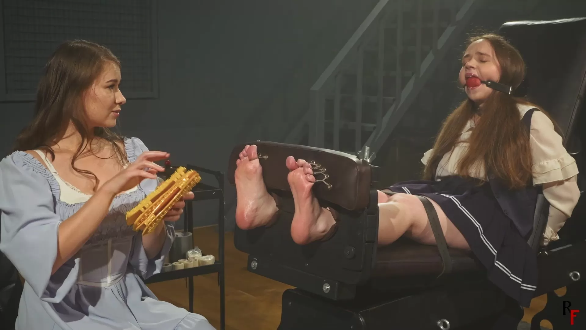 RFStudioProduction – Arina – Foot Tickled by Patty in Stocks with BallGag, Tie.webp
